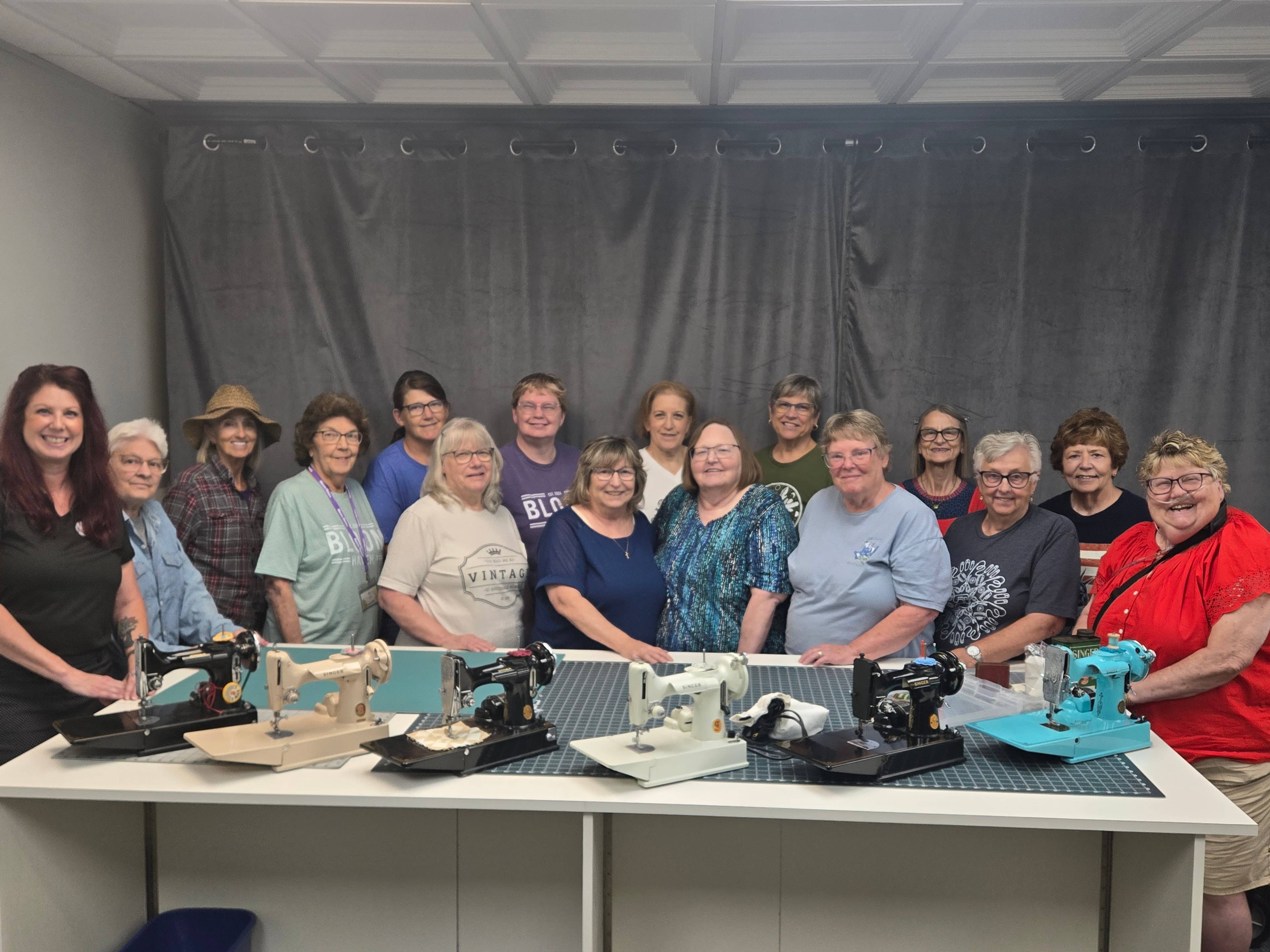 Large group of students with their Singer Featherweight machines at a workshop