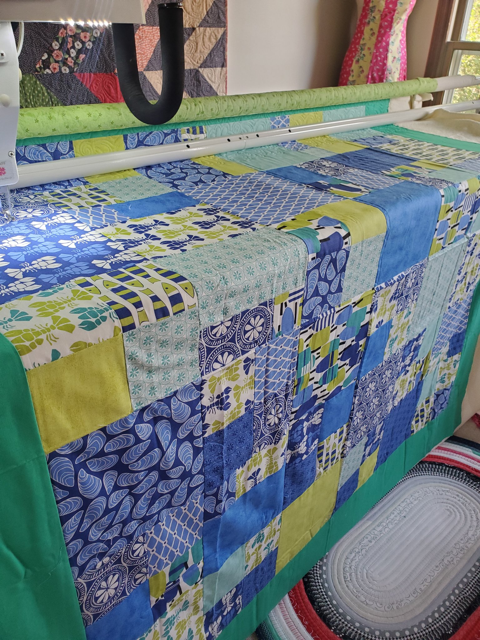 Big Tiff longarm machine quilting a vibrant patchwork quilt