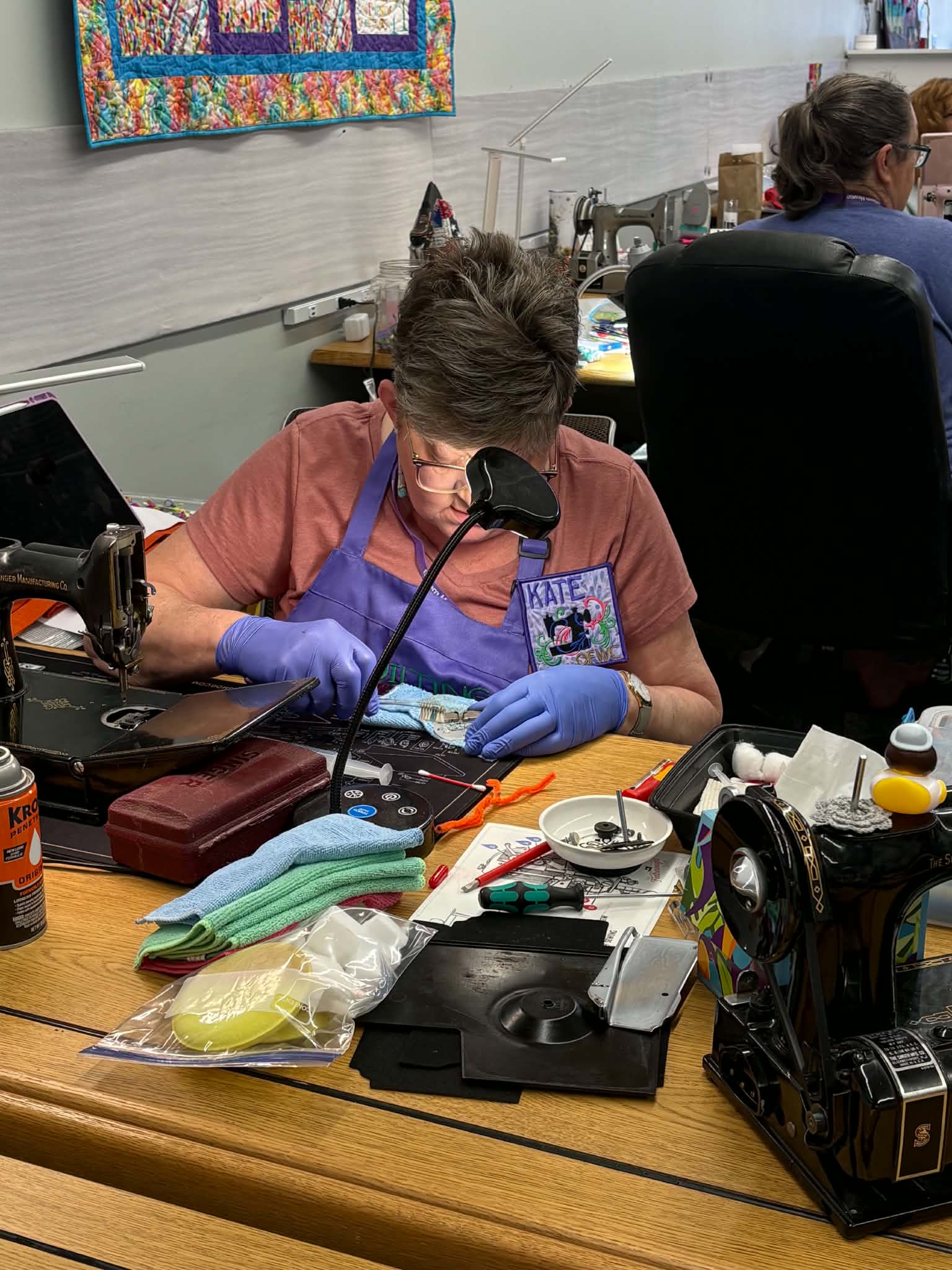 Retreat student carefully cleaning her Featherweight