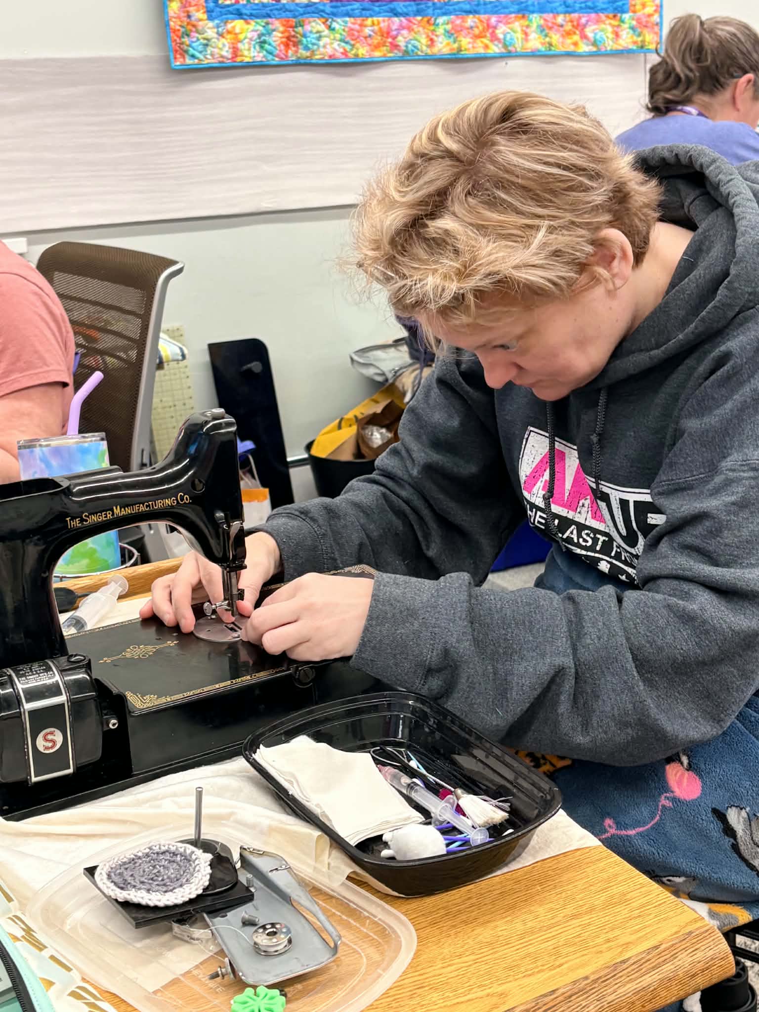 Student working on Singer Featherweight at retreat